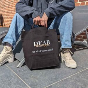 Black Eco tote bag with the message dear stranger, be kind to yourself