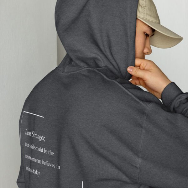 Unisex dark heather grey hoodie with the message "Dear stranger, your smile could be the reasons someone believes in kindness today"